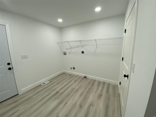 laundry area featuring hookup for an electric dryer, laundry area, washer hookup, baseboards, and light wood-style floors