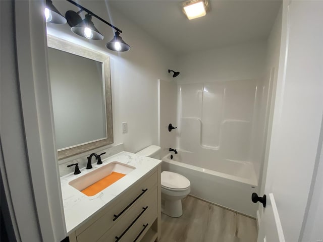 full bathroom with bathtub / shower combination, vanity, toilet, and wood finished floors