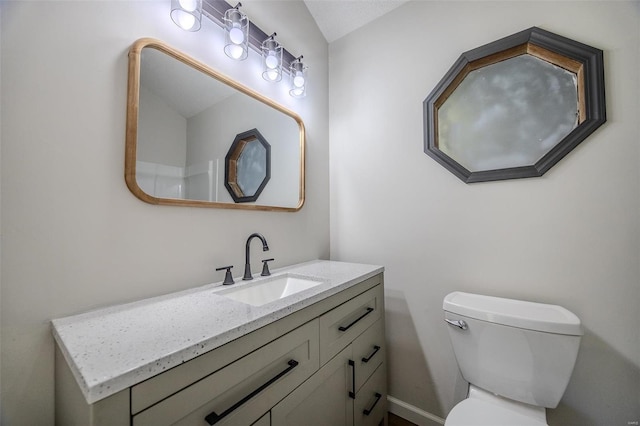 bathroom featuring toilet and vanity