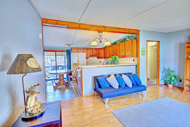 living room with light wood finished floors and beamed ceiling