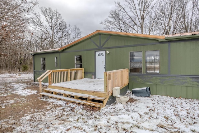 exterior space with metal roof and a deck