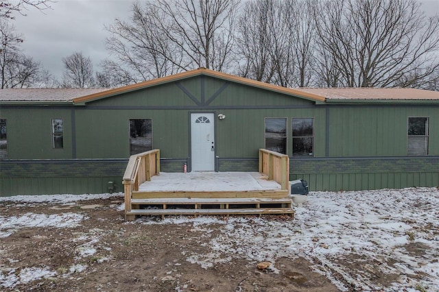 view of front of house with metal roof and a wooden deck