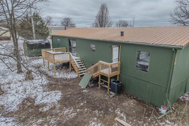 back of house featuring stairs, a deck, metal roof, and cooling unit