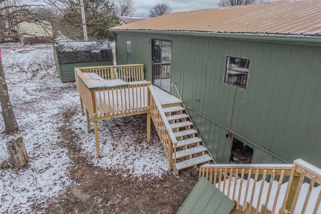 snow covered deck featuring stairs