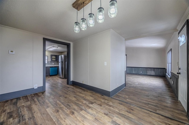 empty room with dark wood-type flooring, crown molding, and a textured ceiling