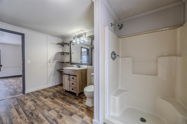 bathroom with wood finished floors, a textured ceiling, toilet, and walk in shower