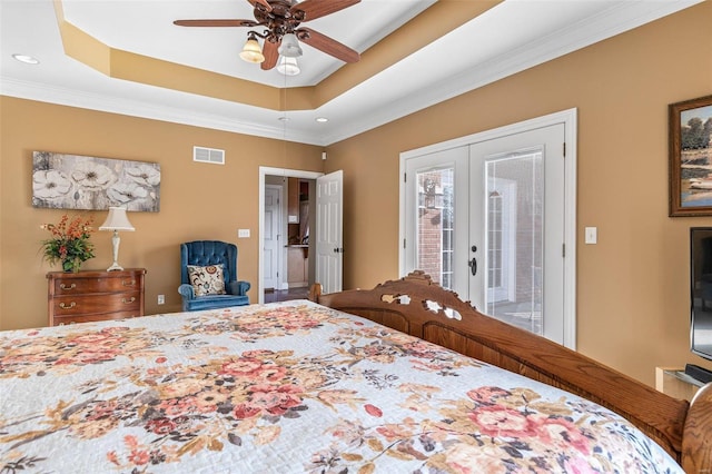 bedroom featuring a raised ceiling, access to outside, french doors, and visible vents