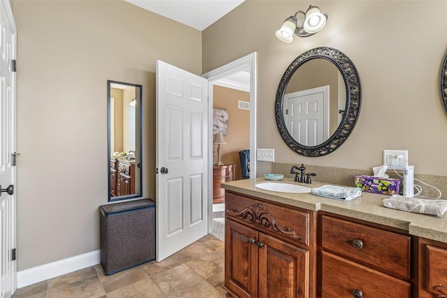 bathroom with visible vents, baseboards, and vanity