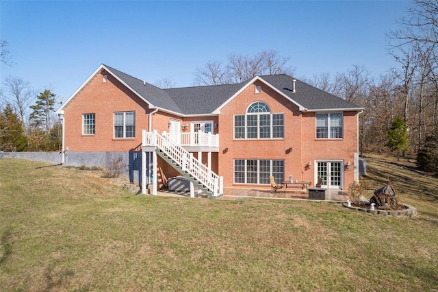 back of house with a yard, french doors, stairway, a wooden deck, and brick siding