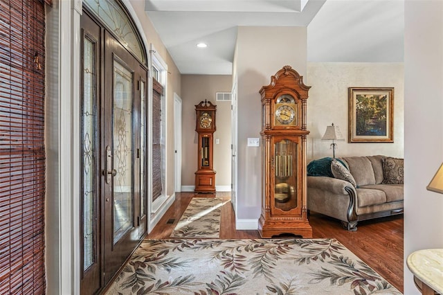 foyer entrance with visible vents, recessed lighting, baseboards, and wood finished floors