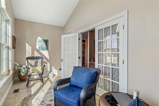 sitting room featuring visible vents, baseboards, high vaulted ceiling, and tile patterned flooring