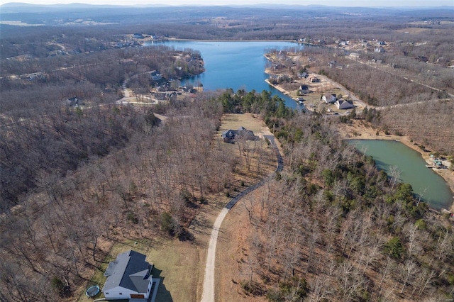 aerial view with a forest view and a water view