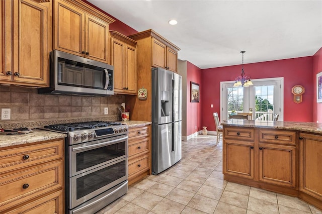 kitchen featuring tasteful backsplash, light tile patterned floors, french doors, brown cabinetry, and stainless steel appliances