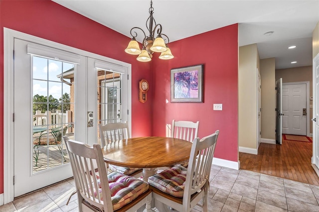 dining area featuring recessed lighting, french doors, light tile patterned floors, baseboards, and a chandelier