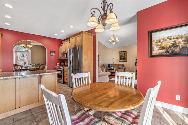 dining area with light tile patterned floors, an inviting chandelier, recessed lighting, arched walkways, and vaulted ceiling