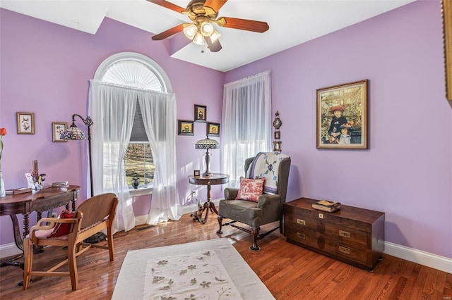 home office featuring ceiling fan, baseboards, and wood finished floors