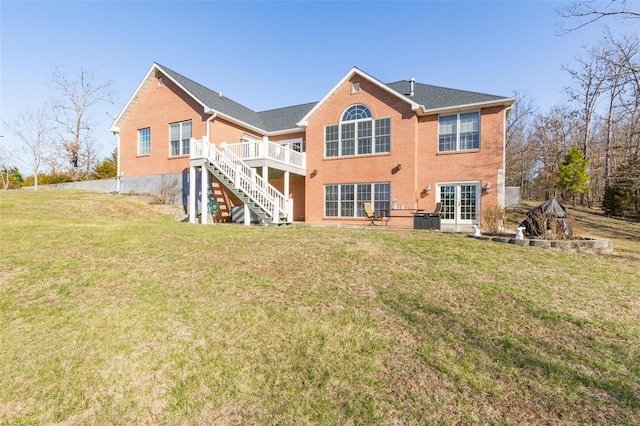 back of house with a lawn, french doors, stairway, a wooden deck, and brick siding