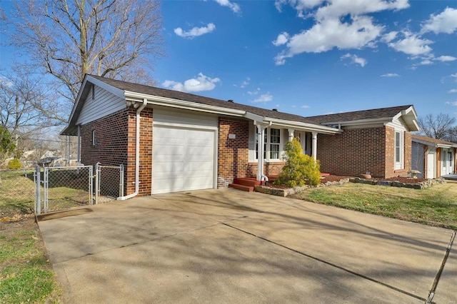 single story home with brick siding, fence, concrete driveway, a garage, and a gate