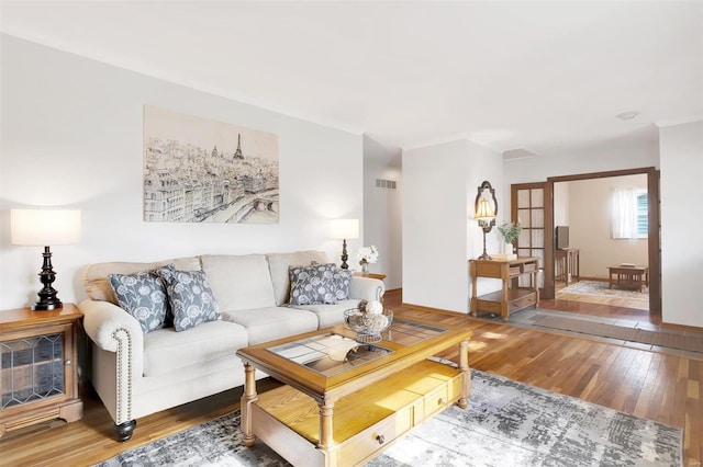 living room featuring visible vents and wood-type flooring