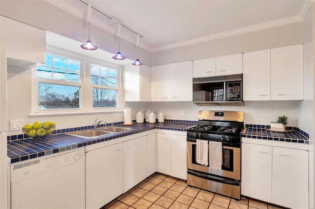 kitchen featuring tile countertops, gas stove, white dishwasher, a sink, and black microwave