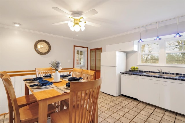 dining room featuring light tile patterned flooring, crown molding, and a ceiling fan