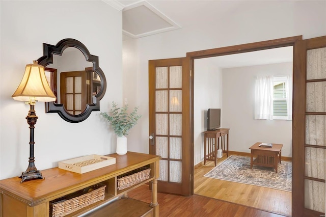 entryway with wood finished floors and french doors