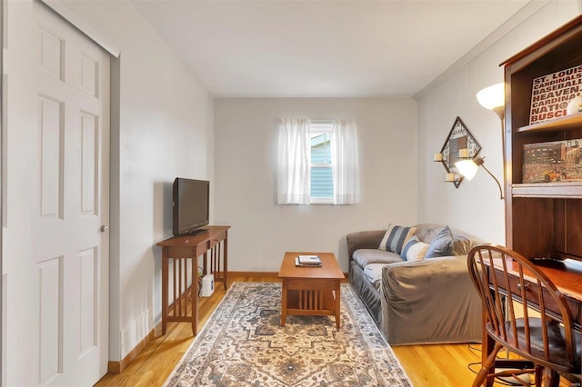 sitting room with light wood-type flooring and baseboards