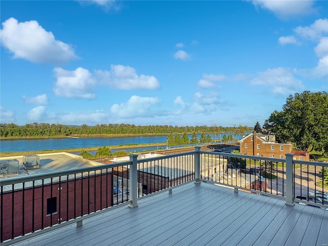 wooden terrace featuring a water view