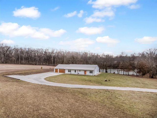 view of front of property with a garage, driveway, and a front lawn