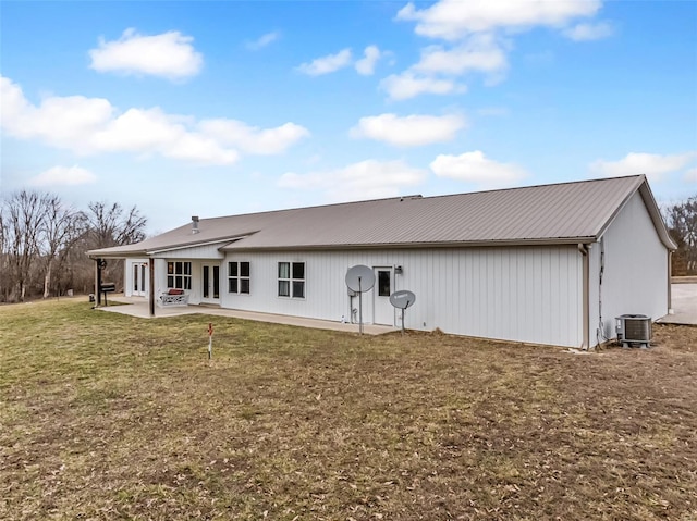 rear view of house with a patio, central air condition unit, a yard, and metal roof