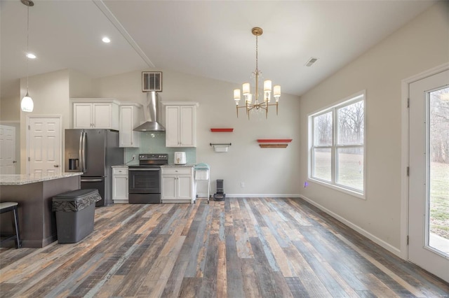 kitchen featuring visible vents, appliances with stainless steel finishes, white cabinets, wall chimney range hood, and vaulted ceiling