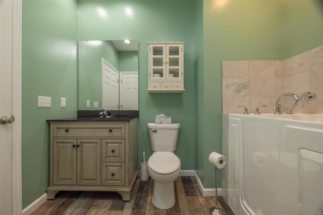 full bath featuring baseboards, toilet, wood finished floors, and vanity