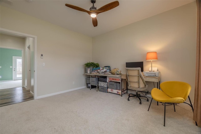 home office with baseboards, a ceiling fan, and carpet flooring