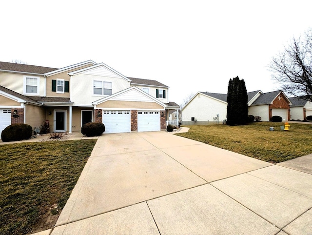 traditional-style house featuring a garage, driveway, brick siding, and a front yard