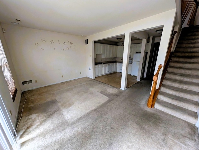 interior space featuring stairway, visible vents, and a sink