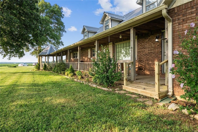 view of yard featuring covered porch