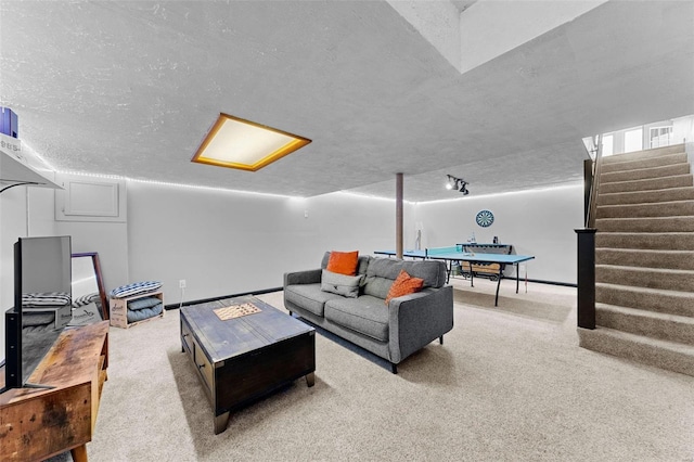 carpeted living area featuring stairway, a textured ceiling, and a baseboard heating unit