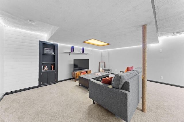 living area with baseboards, carpet floors, and a textured ceiling