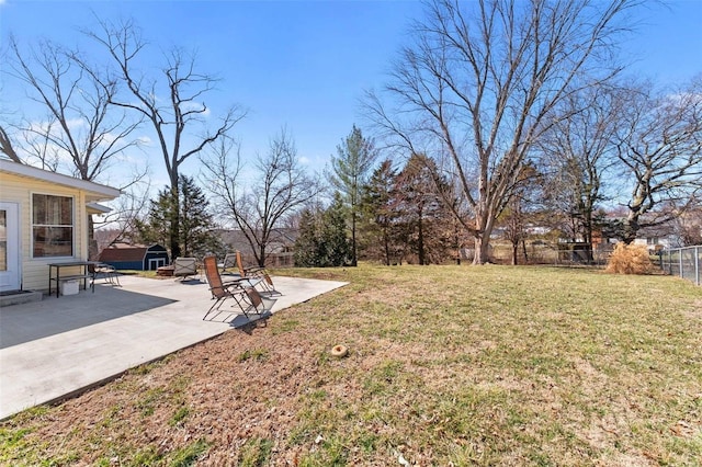 view of yard featuring fence and a patio area