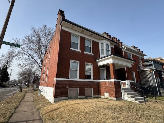 view of property with brick siding