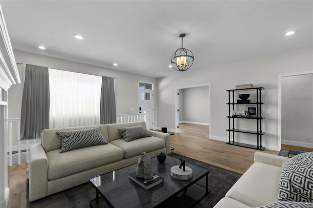 living room with a notable chandelier, recessed lighting, baseboards, and wood finished floors