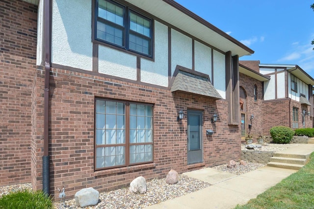 view of front of house with brick siding and stucco siding