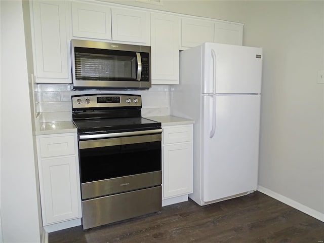 kitchen featuring appliances with stainless steel finishes, white cabinets, and light countertops