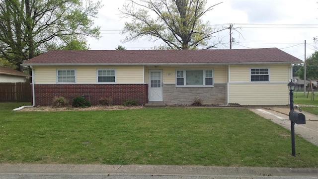 single story home featuring stone siding, a front yard, and fence