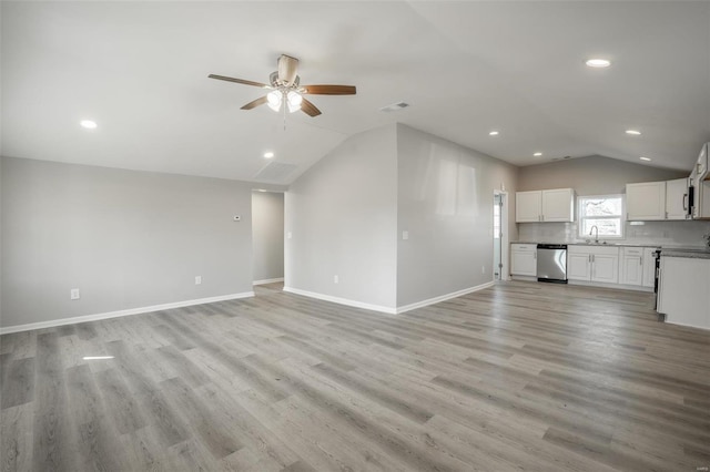 unfurnished living room with lofted ceiling, baseboards, and light wood-style floors