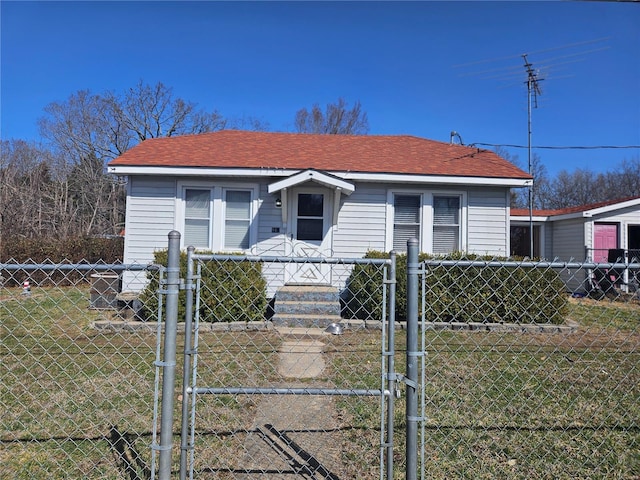 bungalow-style home with a fenced front yard, a front yard, and a gate