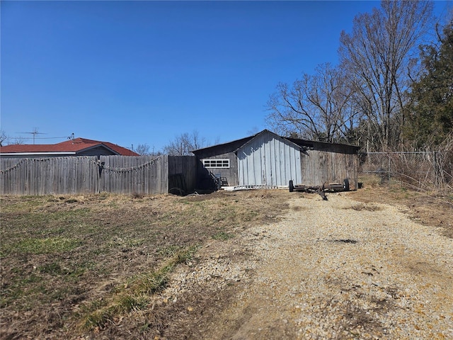 exterior space with an outbuilding and fence