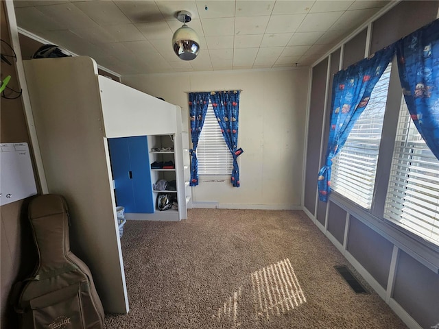 unfurnished bedroom with carpet floors and visible vents