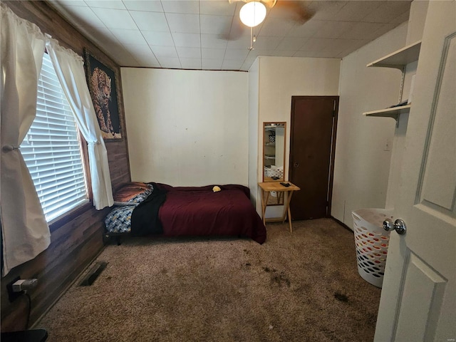 carpeted bedroom featuring ceiling fan and visible vents