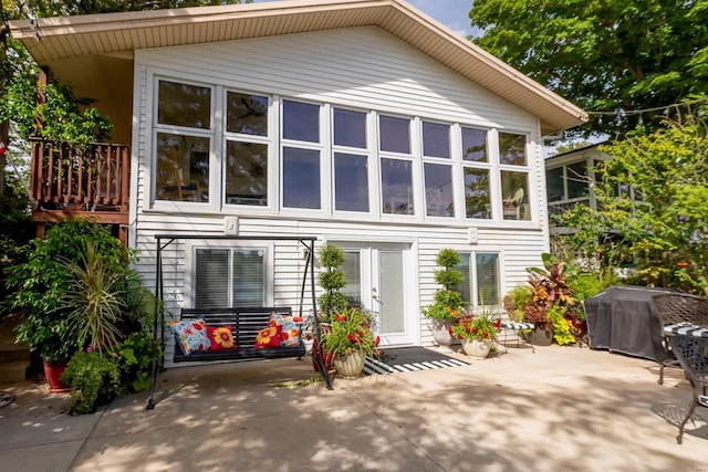 rear view of property with french doors and a patio area